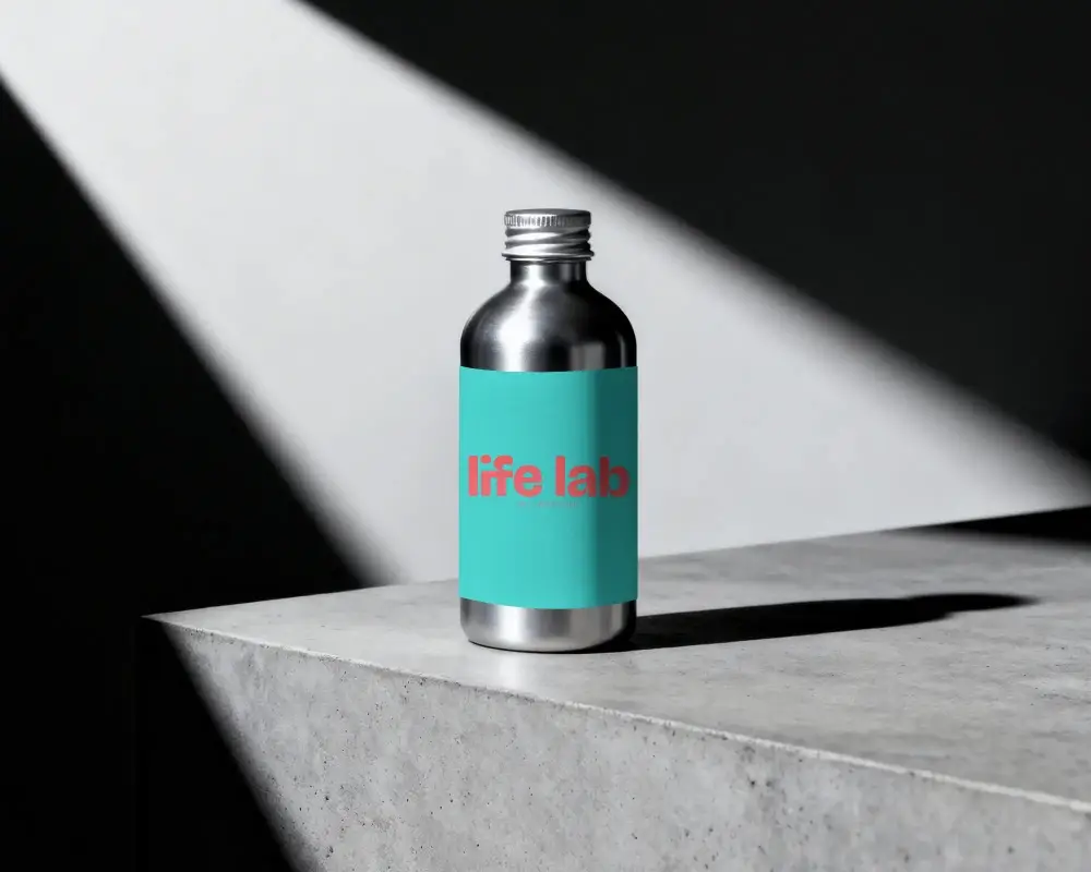 Metallic Bottle Mockup With Clean Label On Concrete Surface Under Dramatic Lighting