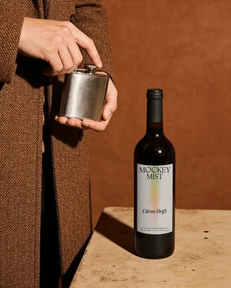 Elegant Wine Bottle Mockup With Simple Label And Metal Flask For Branding Presentation