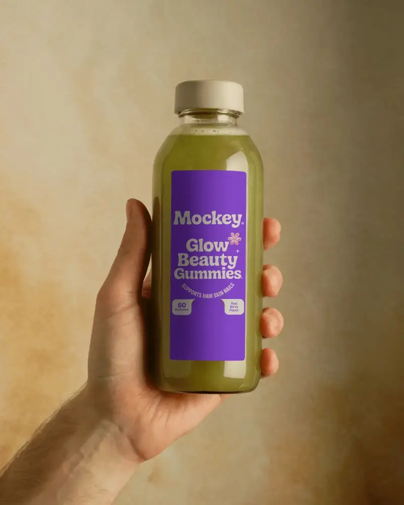 Hand Holding Clear Plastic Bottle With Rectangular Label For Beverage Packaging Mockup