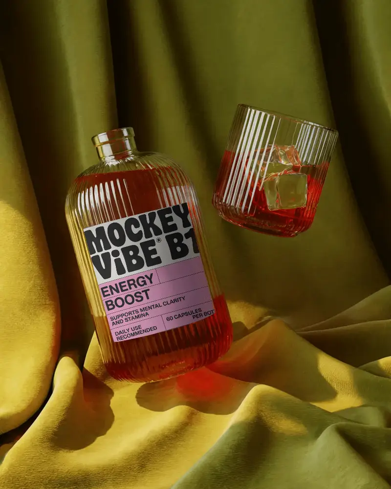 Luxury Ribbed Bottle Mockup With Clear Glass And Blank Label On Draped Fabric Background