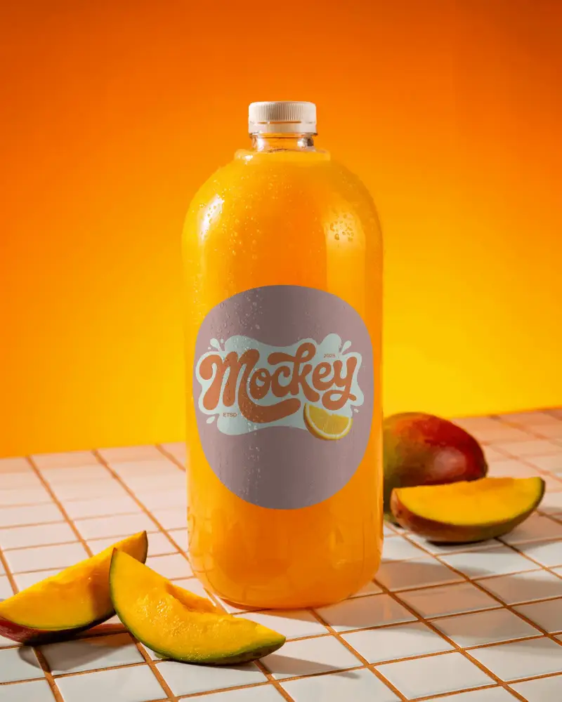 Chilled Fruit Juice Plastic Bottle Mockup With Mango Slices On Tiled Table
