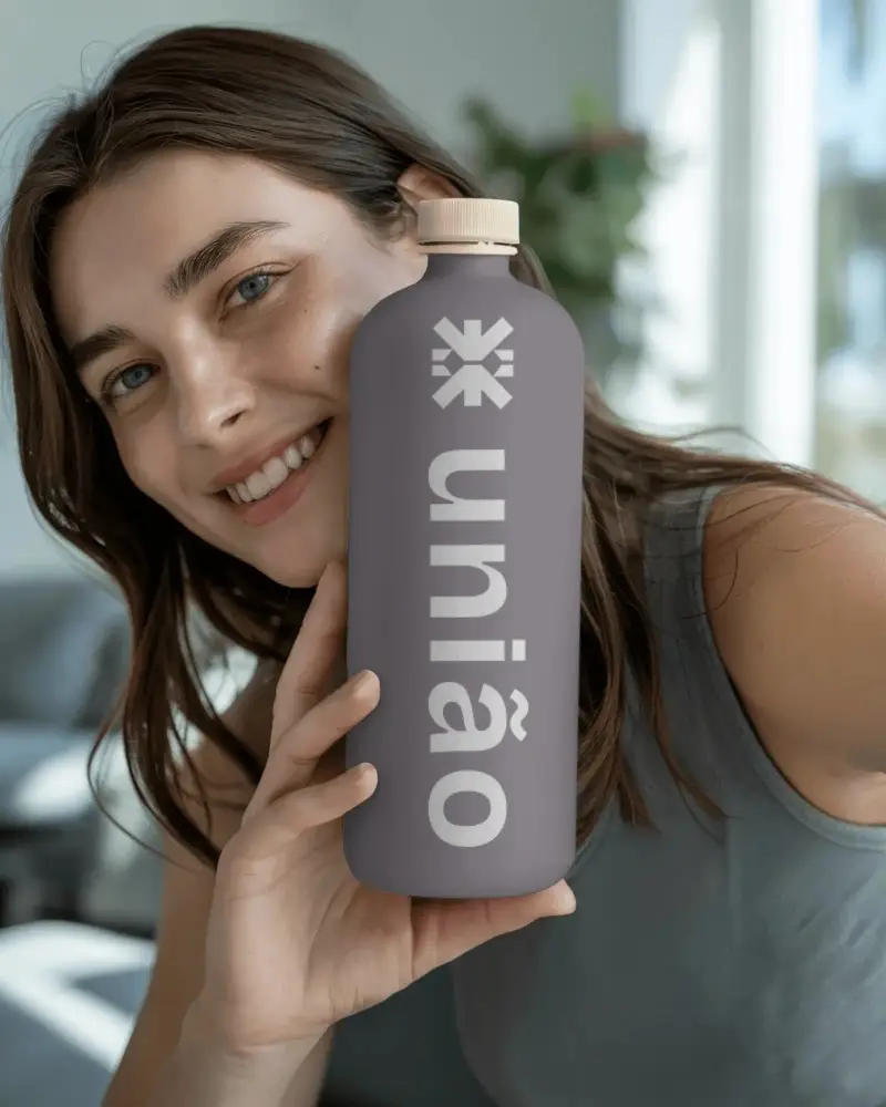 Woman Holding Minimalist Bottle Mockup Showing Modern Packaging Design Idea Concept