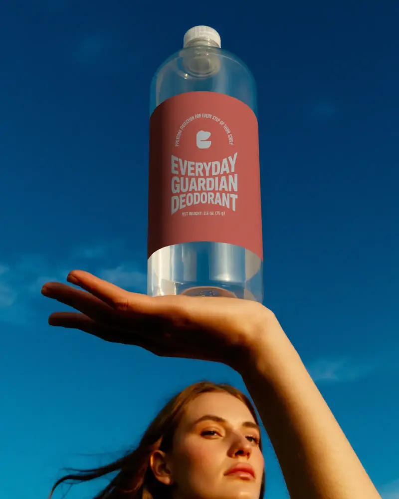 Hand Holding Blank Bottle Mockup Showcasing Label Design On Transparent Container