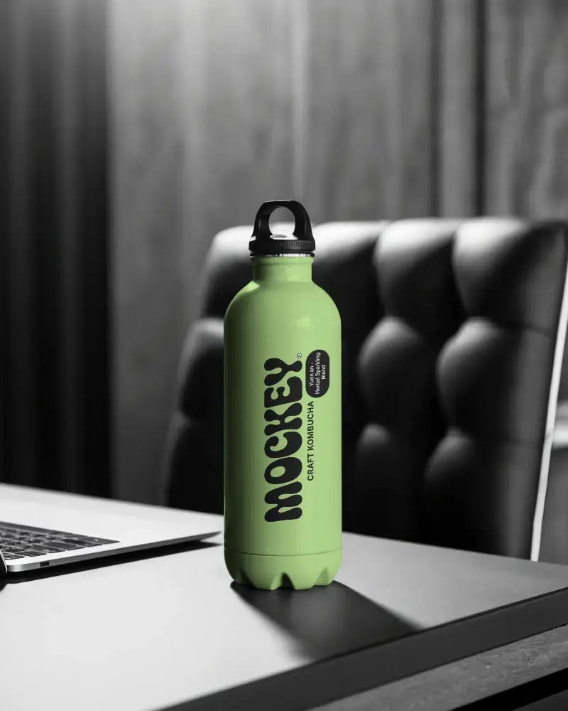 Premium Stainless Steel Bottle Mockup On Desk With Laptop And Leather Chair