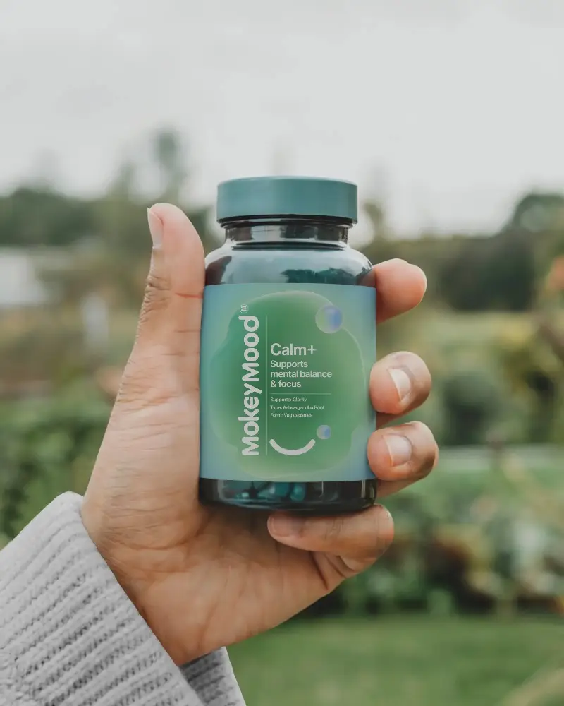 Hand Holding Clear Bottle Mockup With Black Label Capsule Supplement Container Mockup Outdoor