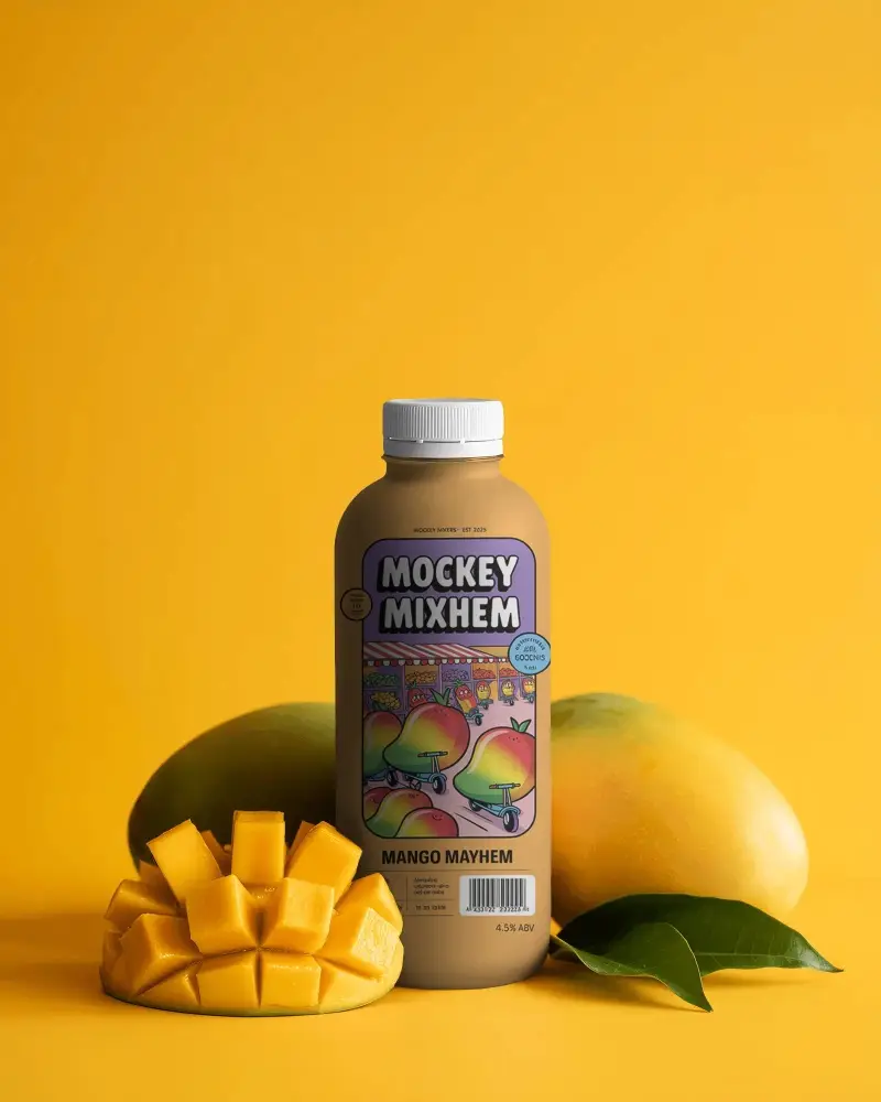 Mango Fruit Juice Bottle Mockup With Fresh Sliced Mango And Leaf On Monochrome
