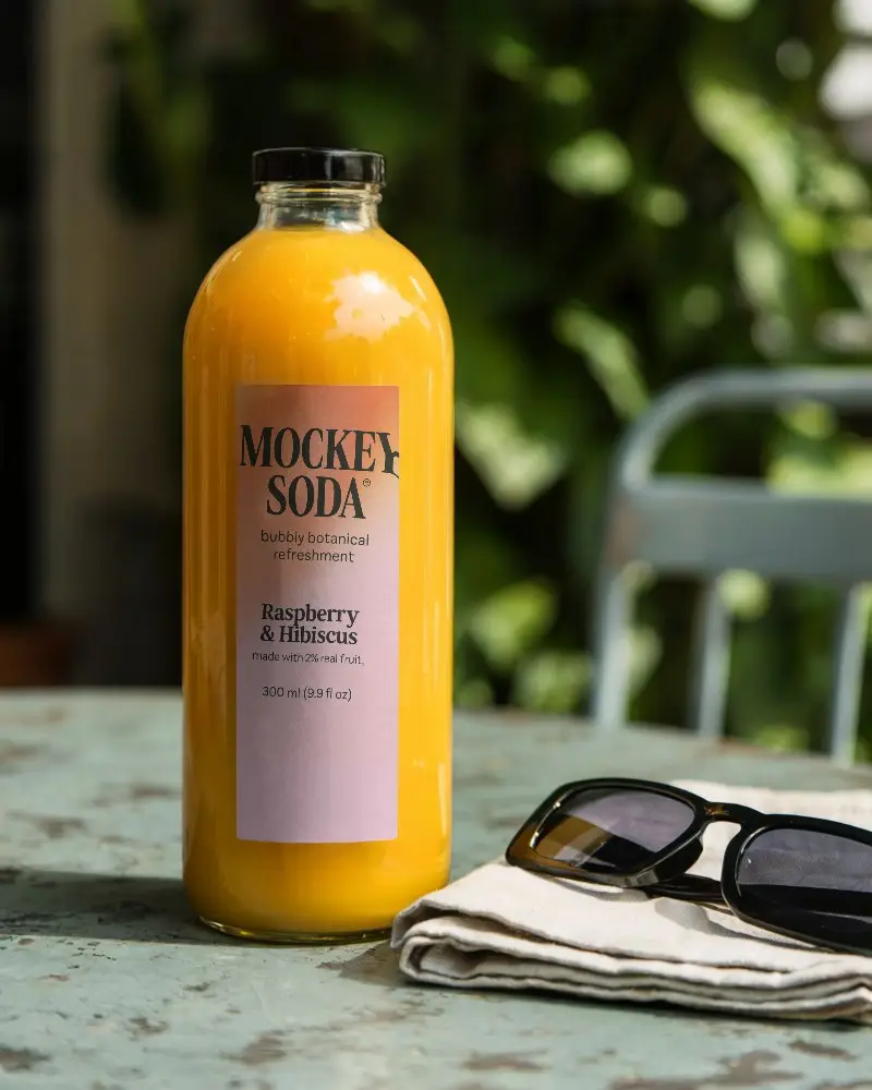 Premium Glass Juice Bottle Mockup On Rustic Table With Folded Napkin And Sunglasses 0217