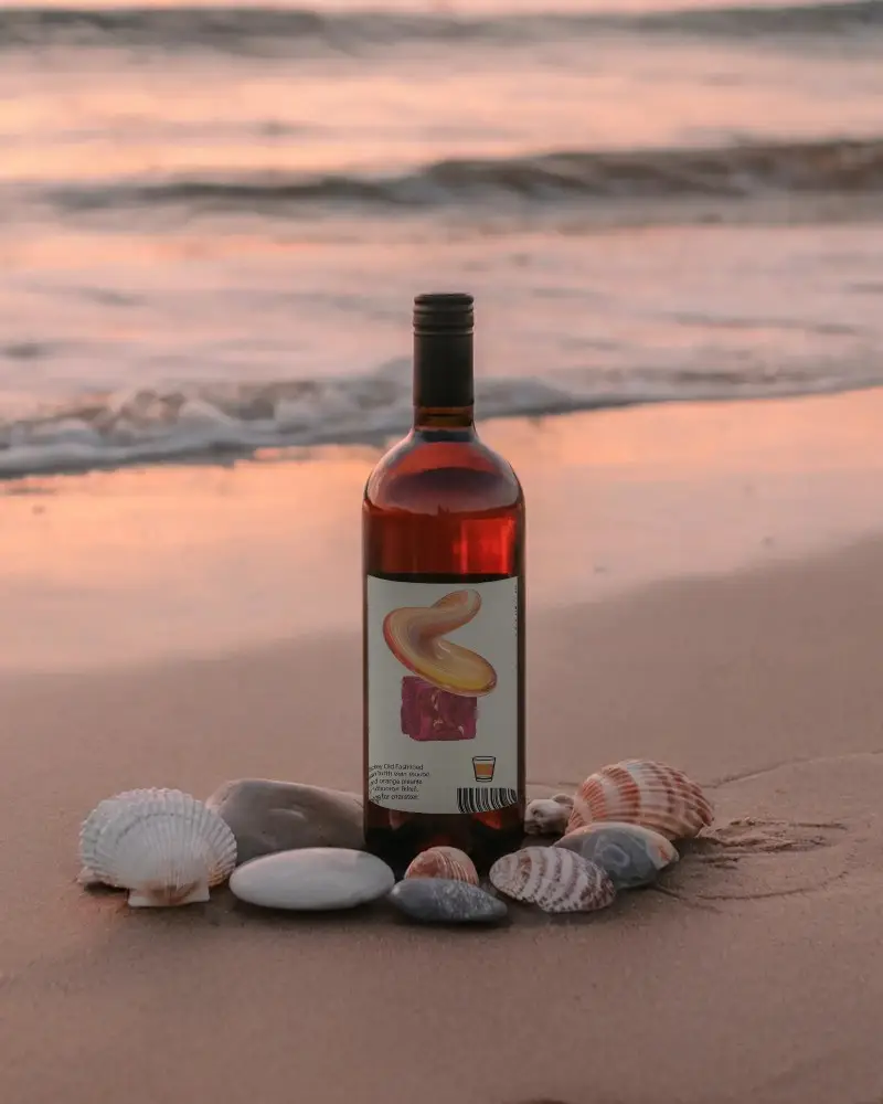 Elegant Wine Bottle Mockup With Seashells On Sandy Beach During Sunset Scene