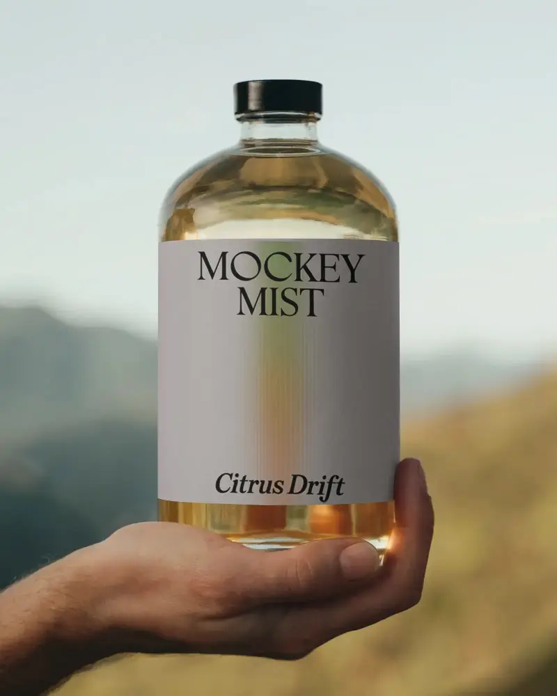 Premium Clear Bottle Mockup Held In Hand With Blank Label For Branding Designs