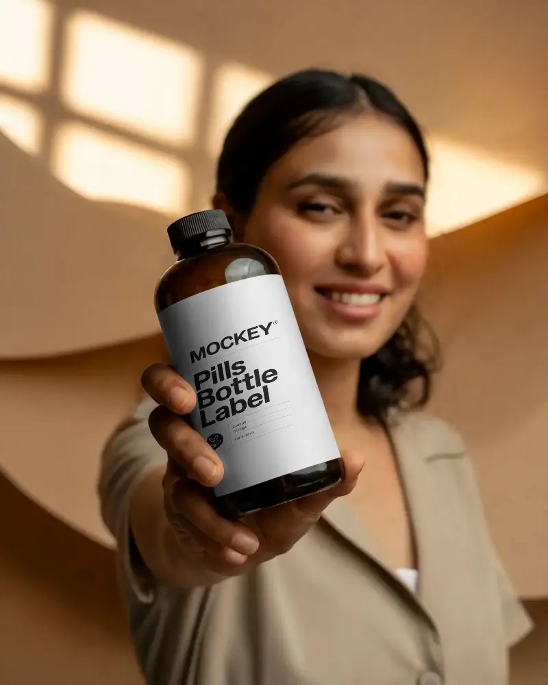 Hand Holding Clear Bottle Mockup For Product Presentation And Branding Designs