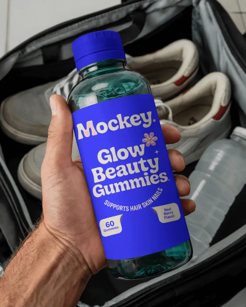 Water Bottle Mockup Held In Hand Above Open Gym Bag With Sneakers