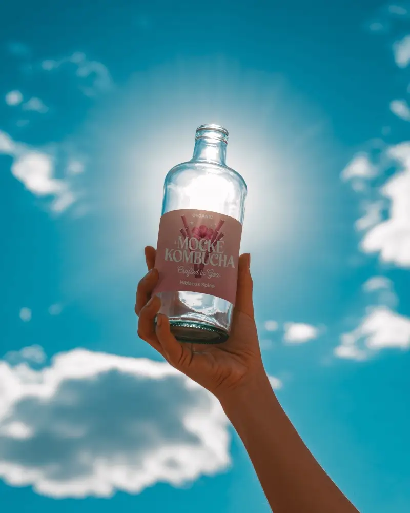 Hand Holding Glass Bottle Mockup For Drink Packaging Or Creative Product Display Presentation