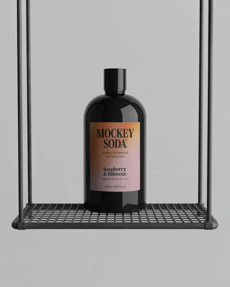Sleek Black Bottle Mockup On Industrial Hanging Metal Shelf For Product Presentation