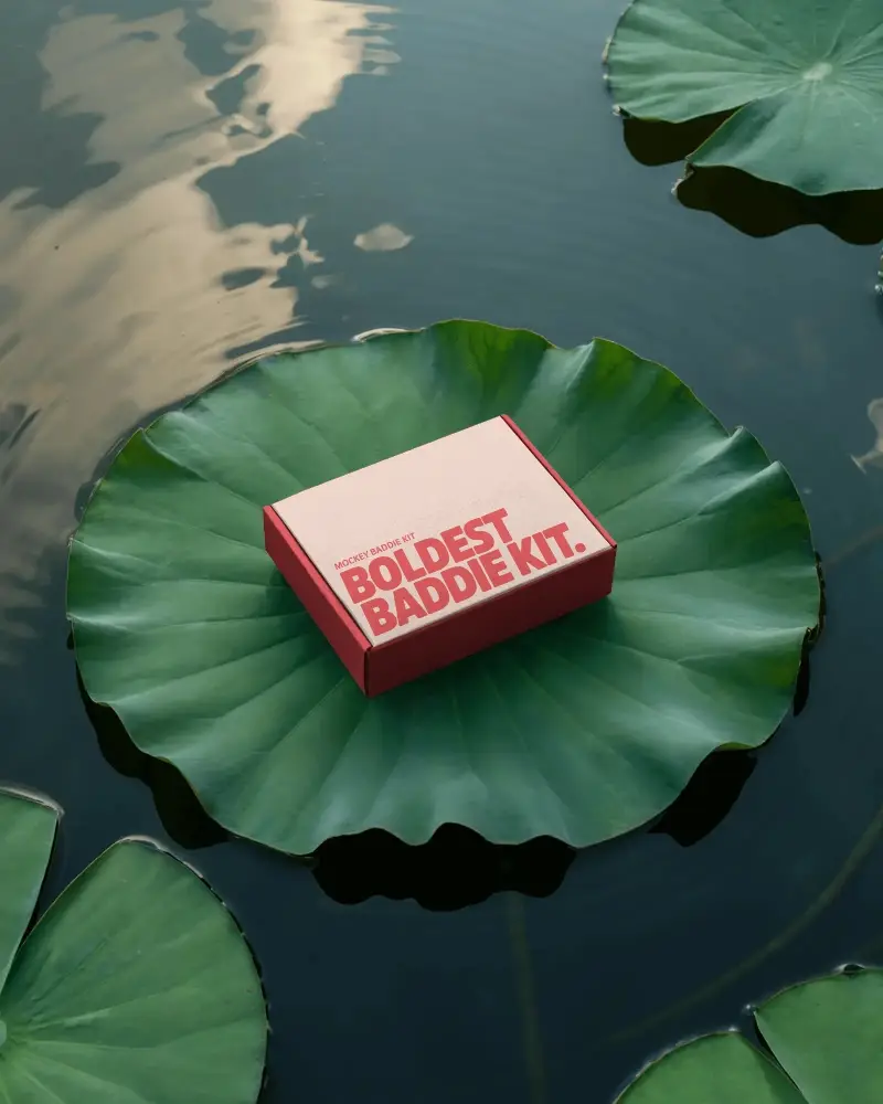 nature-inspired-box-mockup-resting-on-large-green-lily-pad-floating-serenely-in-pond