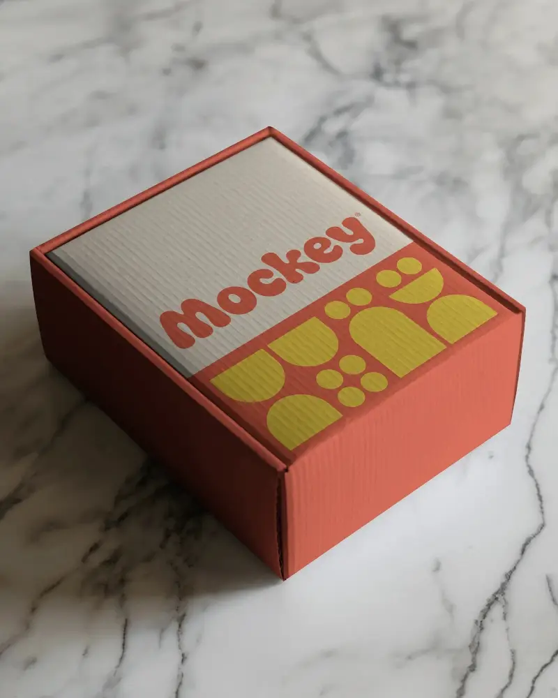 Cardboard Box Mockup On White Marble Surface With Soft Natural Lighting For Premium Style