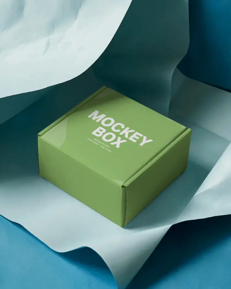 small-cardboard-box-mockup-on-blue-paper-sheets-for-stylish-minimal-brand-packaging