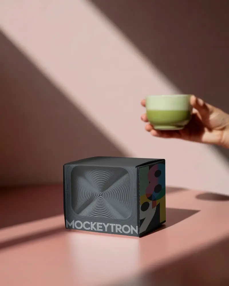 Minimalist Craft Box Mockup On Matte Surface With Natural Light And Hand Holding Cup