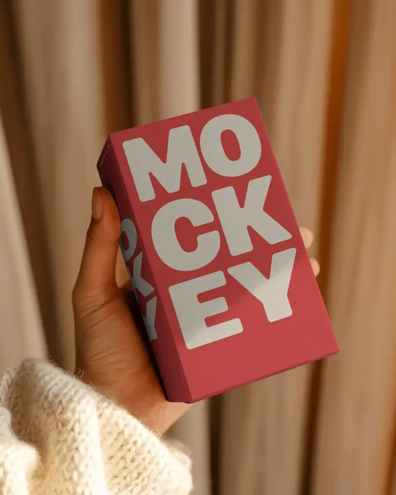 Warm Cozy Handheld Box Mockup With Soft Knit Sleeve And Gentle Natural Curtain Backdrop
