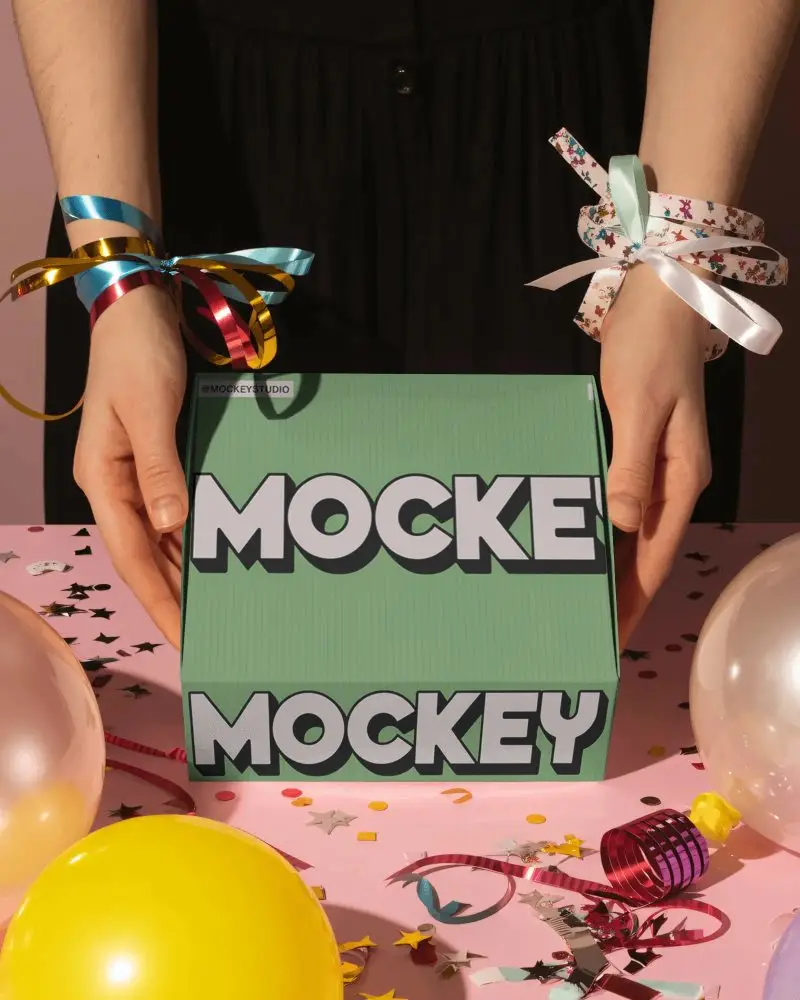 Vibrant Party Celebration Box Mockup With Colorful Ribbons Balloons And Confetti Filled Tabletop