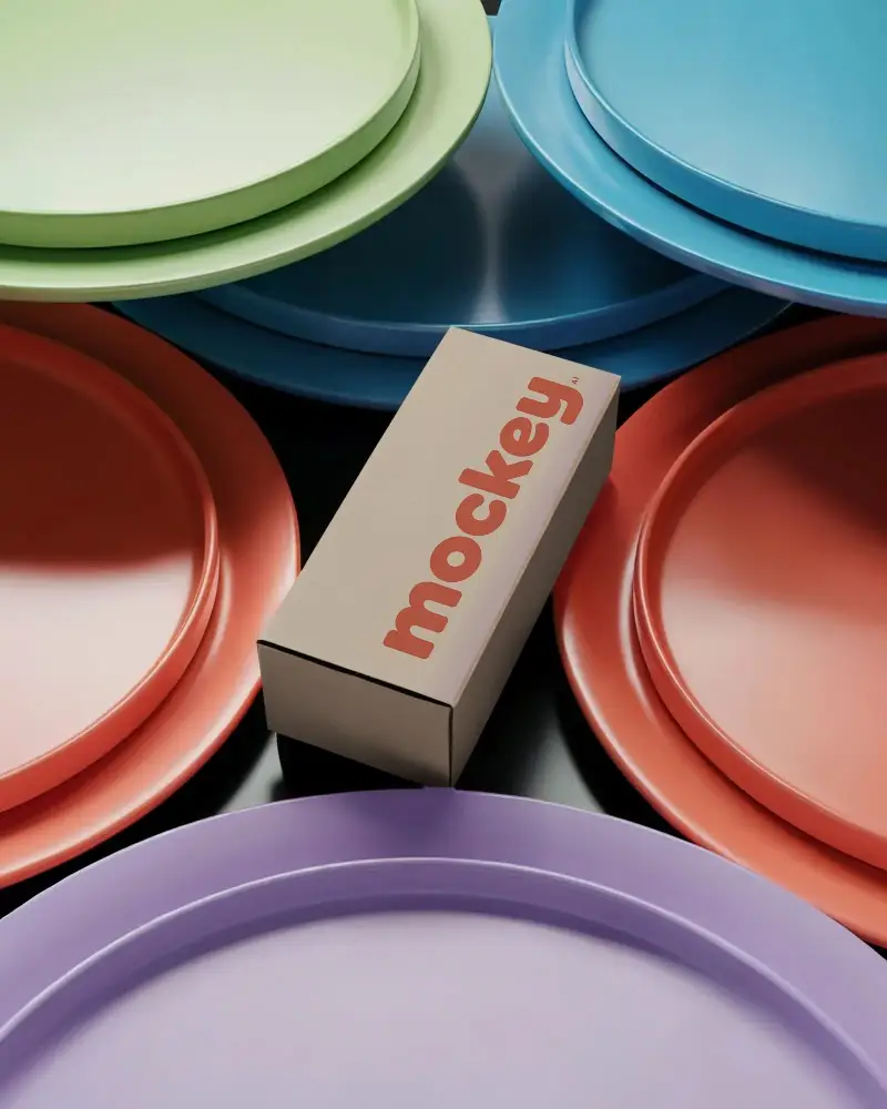 Sleek Modern Box Mockup Placed Among Round Dinner Plates For Stylish Brand Presentation