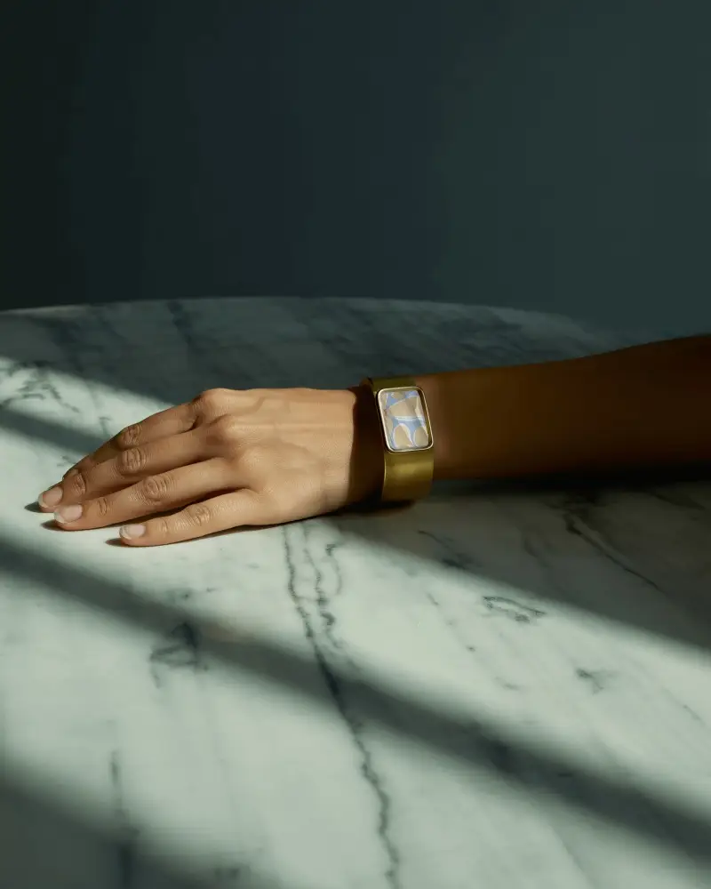 Moody Gold Bracelet Mockup On Hand Resting On Marble Surface With Dramatic Shadows