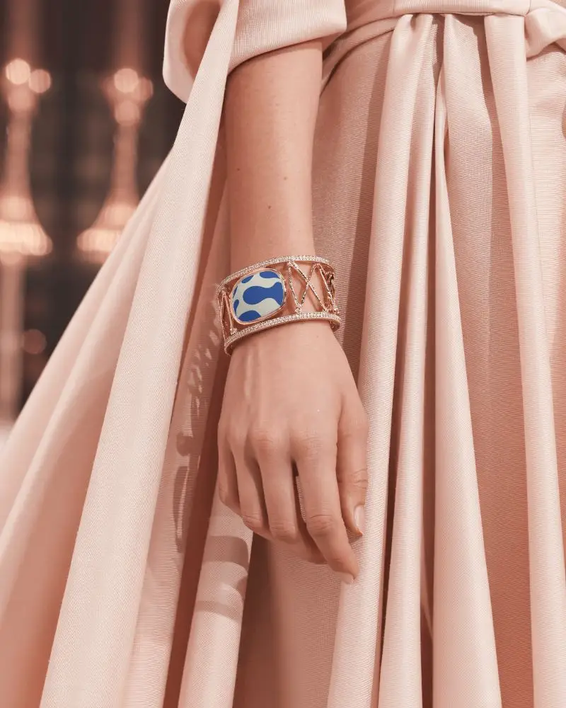 Elegant Rose Gold Bracelet Mockup On Wrist With Flowing Peach Gown Details