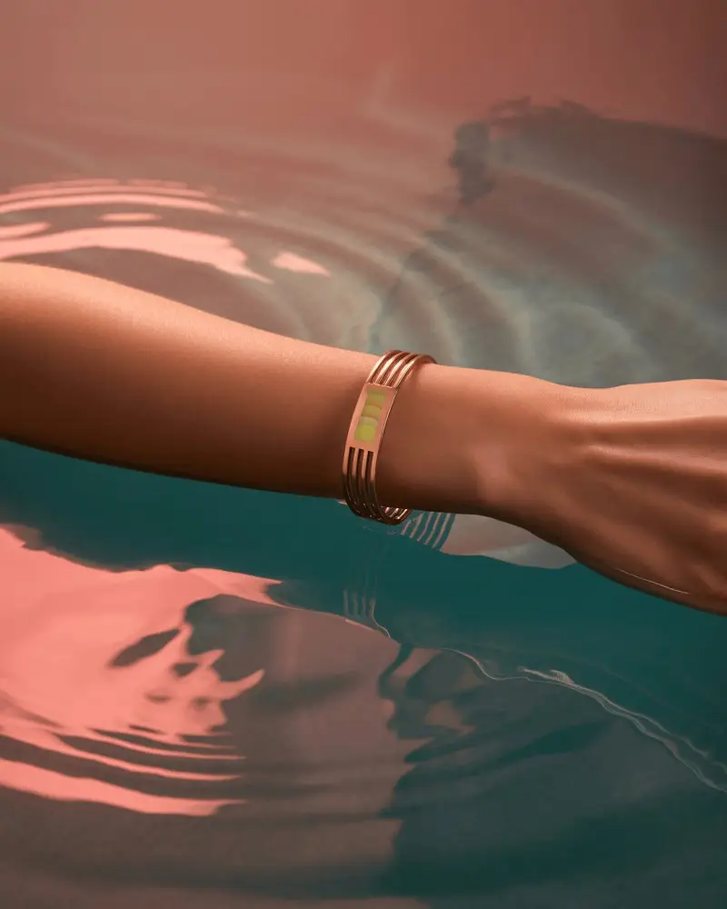 Rose Gold Bracelet Mockup On Wrist Above Water With Soft Pink Reflections
