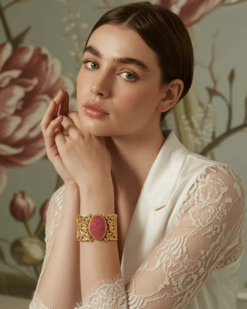 Elegant Gold Bracelet Mockup On Model With Floral Art Backdrop