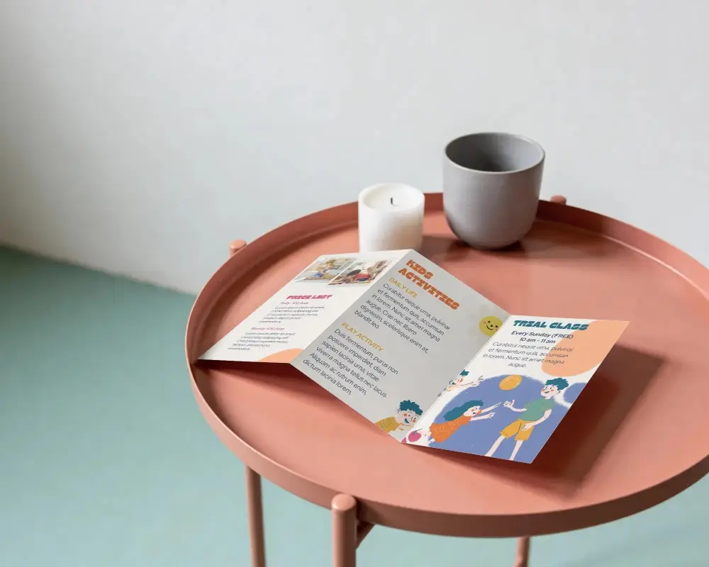 Modern Trifold Brochure Mockup On Stylish Round Table For Design Presentation Display
