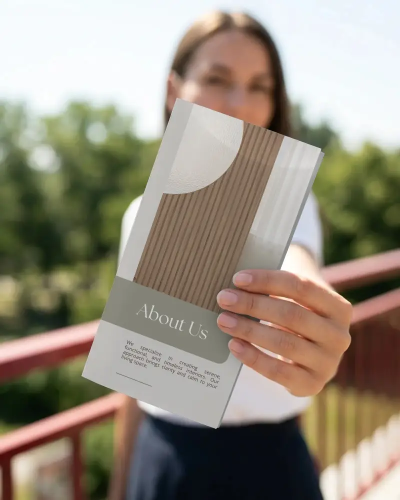 Closeup Of Hand Holding Business Brochure Mockup For Marketing Promotion And Advertisement