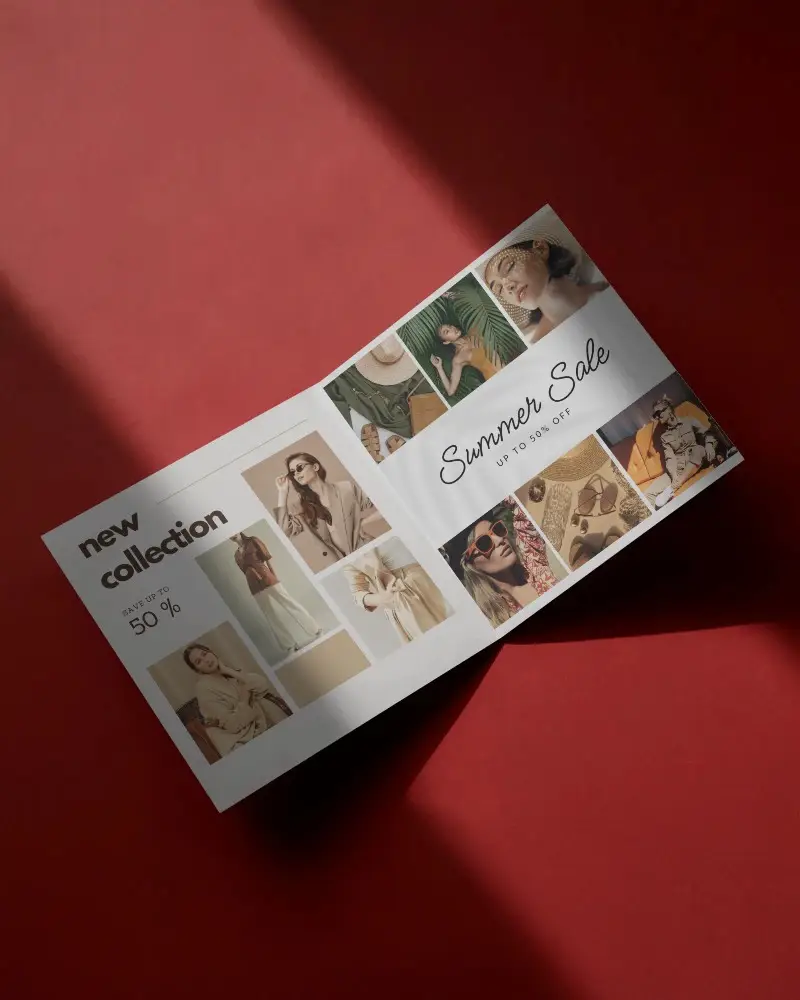 Open Brochure Mockup Half Fold Laying Flat On Red Surface With Dramatic Light And Shadow