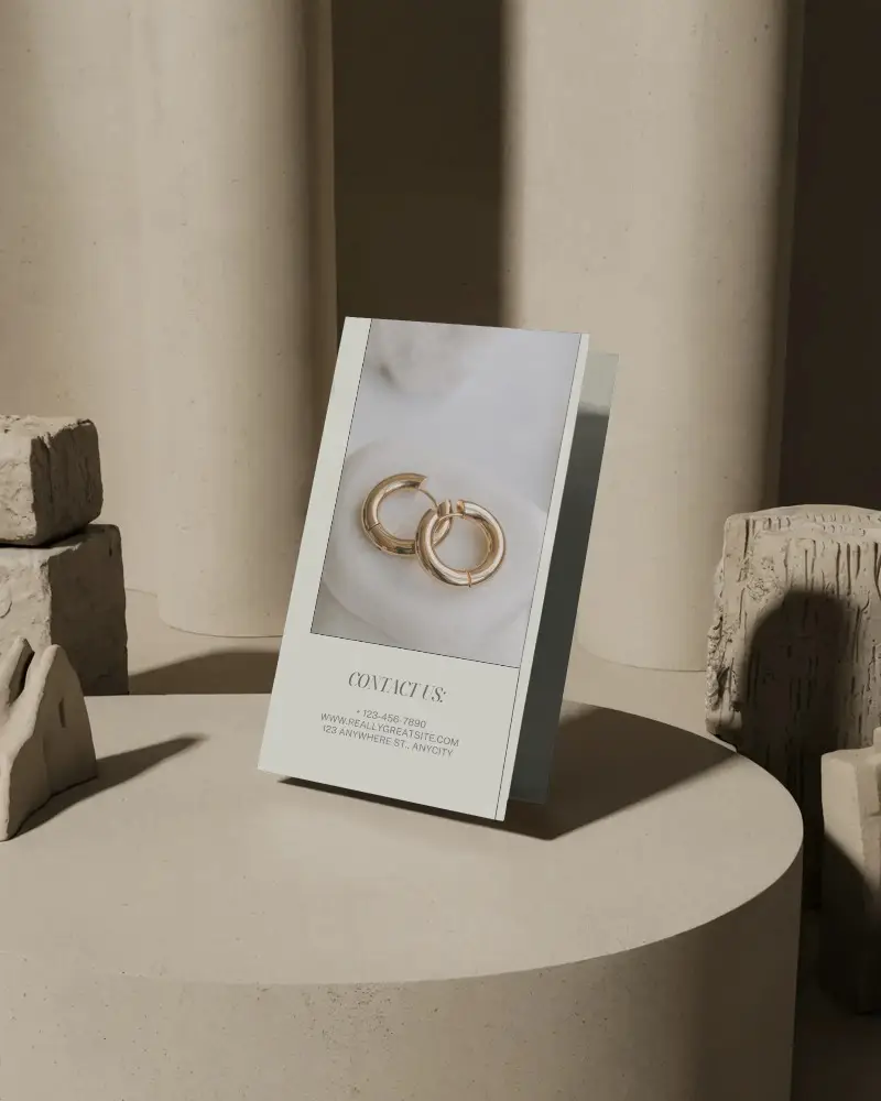 Elegant Brochure Mockup Standing On Round Pedestal With Abstract Sculptural Background