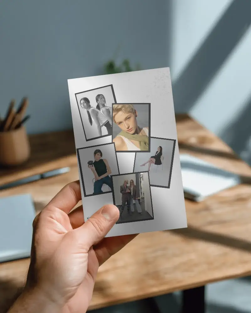 Hand Holding Minimalist Brochure Mockup Over Wooden Desk Background For Print Design