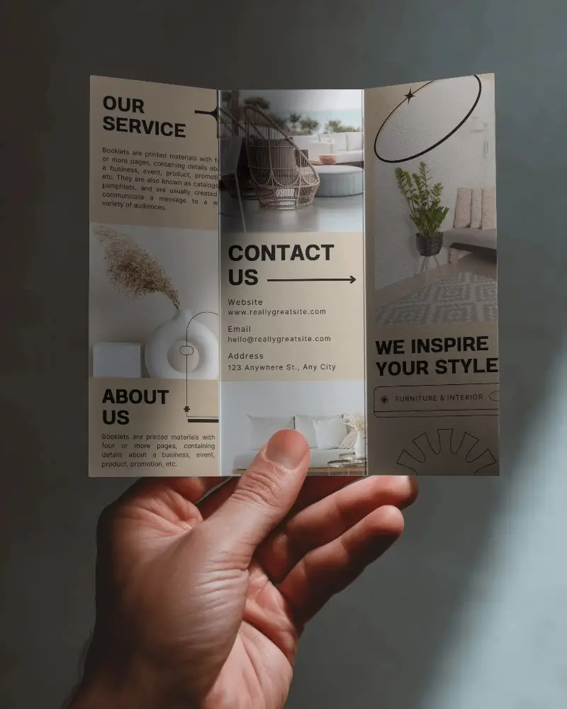 Brochure Mockup Hand Holding Open Trifold Brochure In Moody Natural Light With Soft Shadows