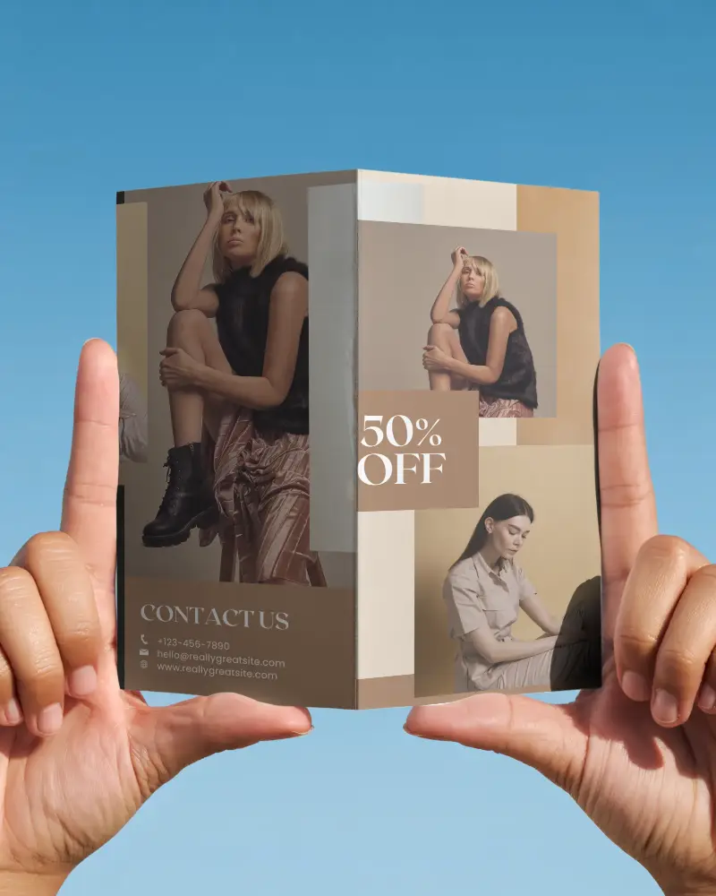 Realistic Brochure Mockup With Dual Panel Holding Hands And Clear Sky Background