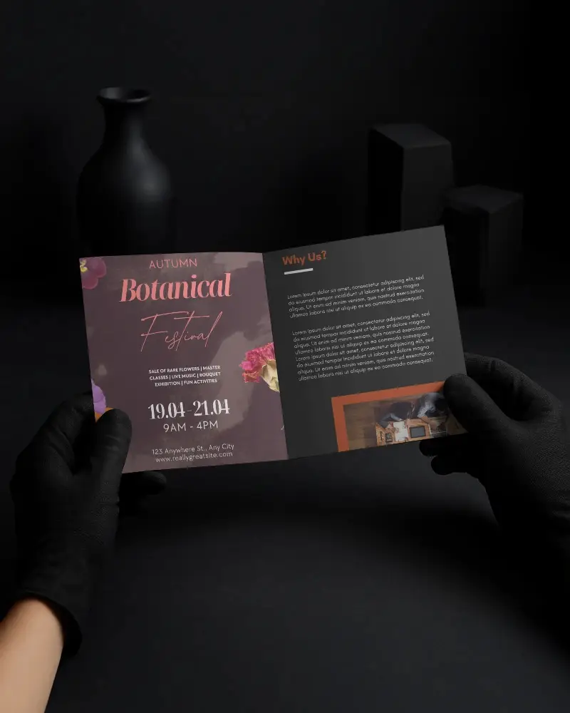Square Brochure Mockup Gloved Hands Holding Open Bifold On Dark Minimalist Surface High Contrast Shadow Presentation