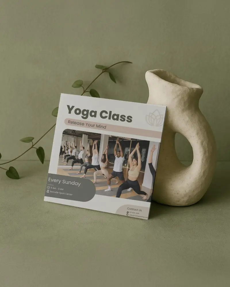 Square Brochure Mockup Against Soft Green Background With Sculptural Stand Featuring Yoga Class Promotion And Group Session Visuals For Serene Marketing
