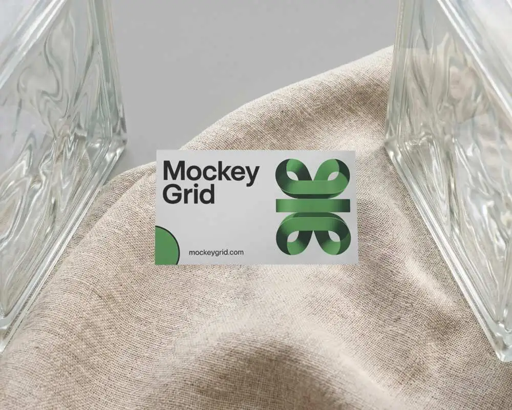 Modern Business Card Mockup On Woven Cloth With Transparent Glass Bottles For Showcase