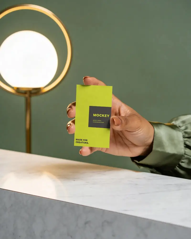 Hand Holding Minimalist Business Card Mockup On Marble Surface With Modern Lighting