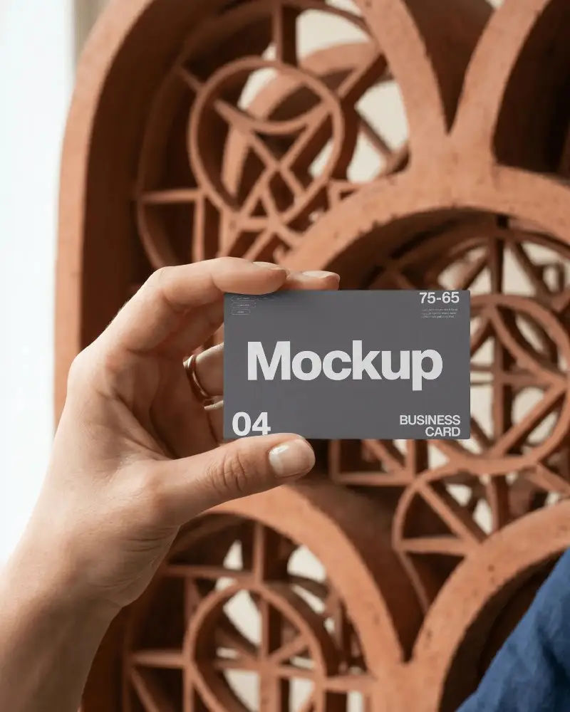Premium Textured Blank Business Card Held In Hand Against Modern Architectural Background