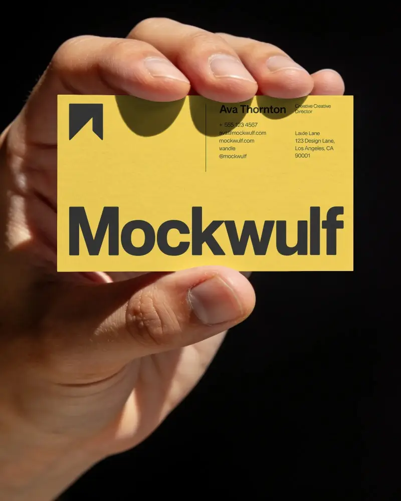 Minimalist Business Card Mockup In Realistic Hand Against Dark Studio Background