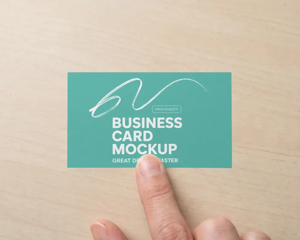 Business Card Mockup With Human Finger Showing Texture On Natural Wood Table Background