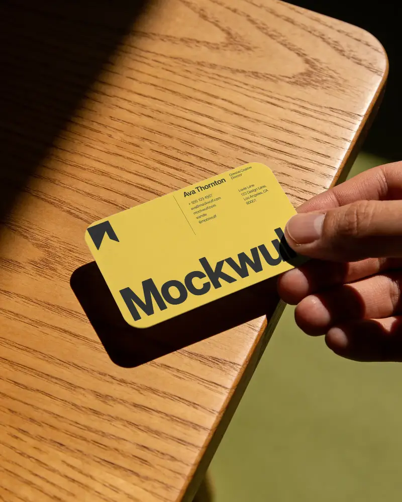 Blank Rectangular Business Card Mockup Rounded Corners Held On Wooden Textured Surface