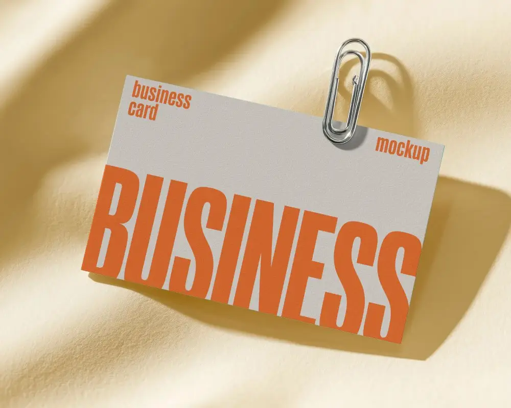 Professional Horizontal Business Card Mockup Held By Metal Paperclip In Studio