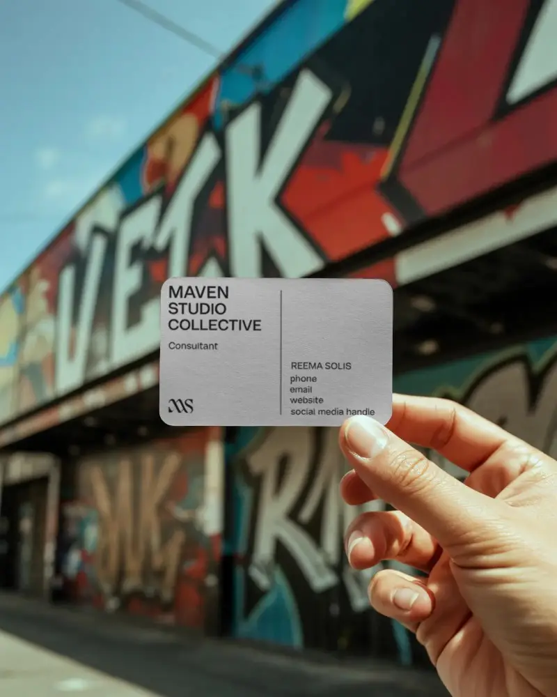 Blank Business Card Mockup Held Near Urban Street Art Wall For Branding
