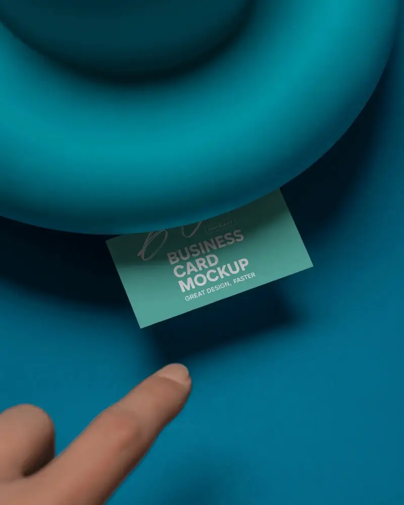 Creative Angled Mockup Showing Business Card Pulling From Smooth Surface With Hand