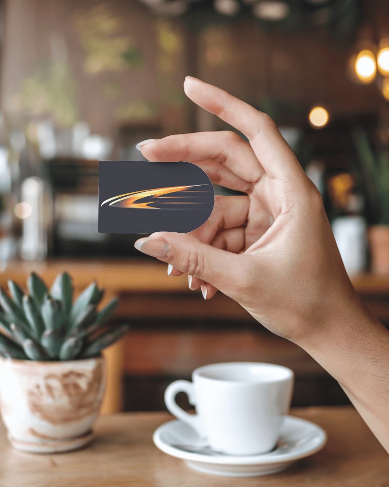 Round Corner Card Mockup Held In Hand With Cafe Cup And Plant Background