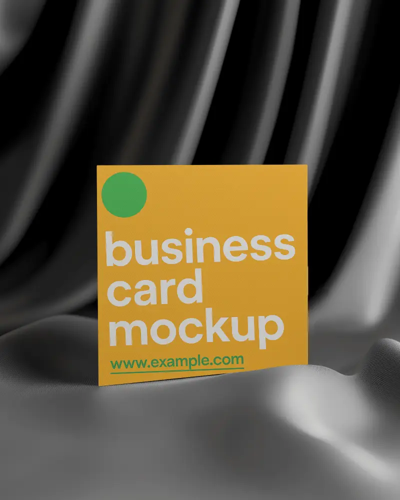 Square Business Card Mockup Standing Upright On Silk Textured Surface Dramatic Black Curtain Background Luxury Studio Brand Presentation Setup