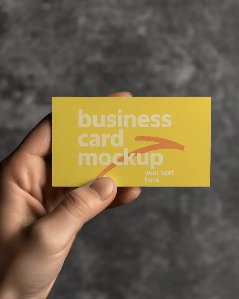 Horizontal Business Card Mockup Hand Holding Against Blurred Dark Concrete Background Clean Minimal Closeup Scene For Modern Brand Identity Display