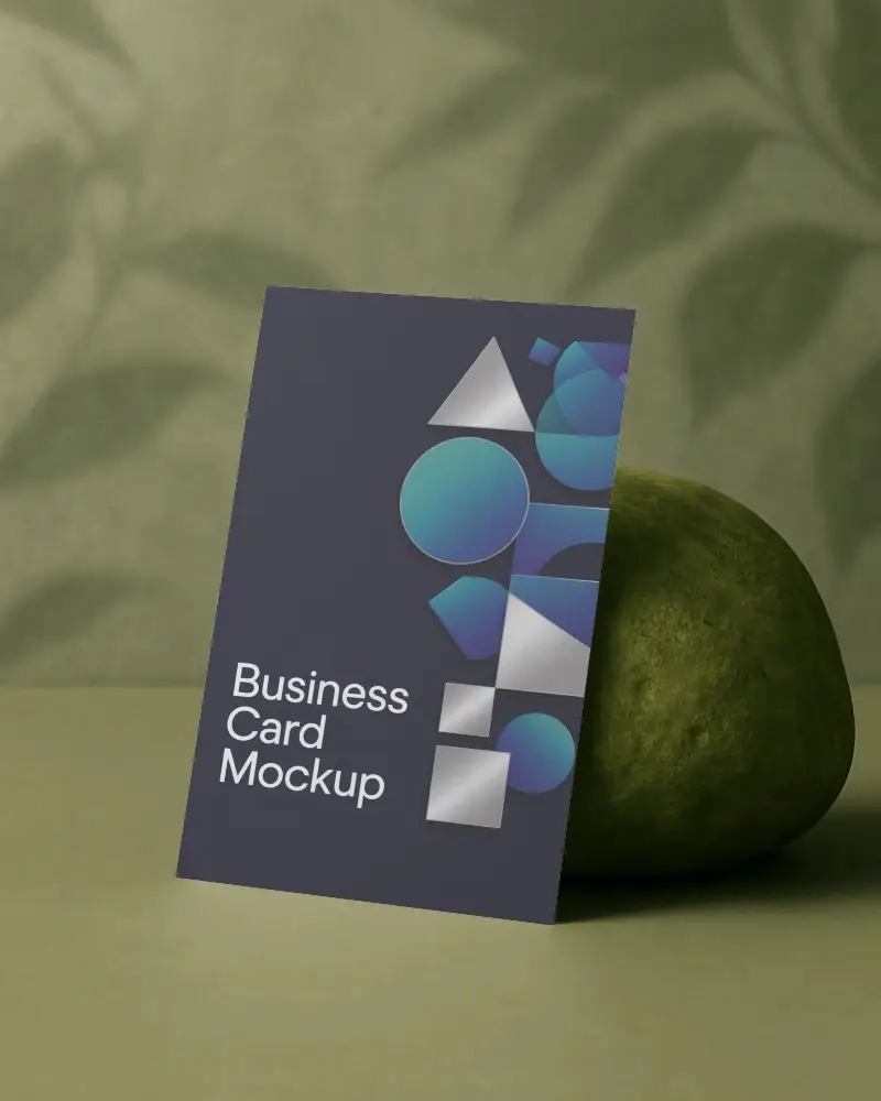 Nature Inspired Business Card Mockup Leaning Against Fruit On Muted Green Surface With Leaf Shadow Background